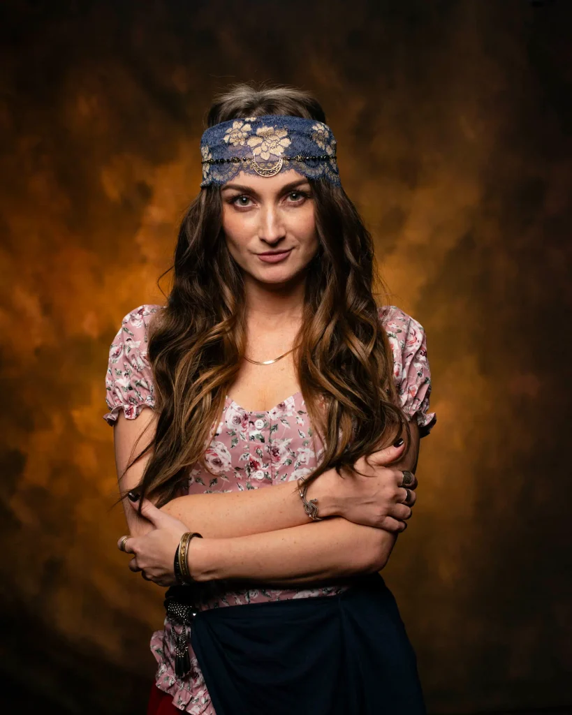 Woman with a headscarf against a warm painted backdrop