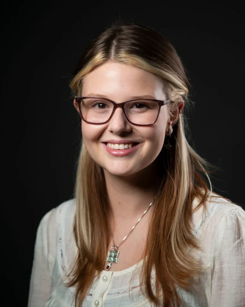 Young woman with glasses, smiling