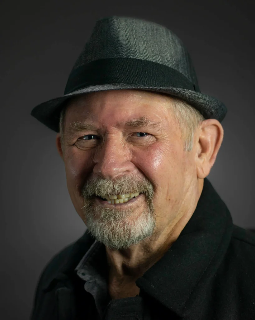 Man in a hat, smiling